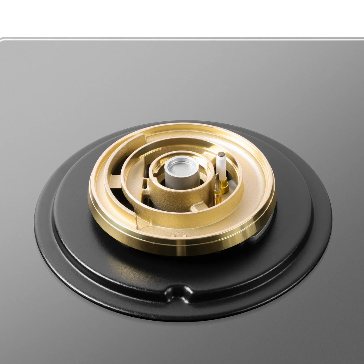 Close-up of the brass burner with ignition electrode on the ROBAM 9B7H31 grey glass gas cooktop