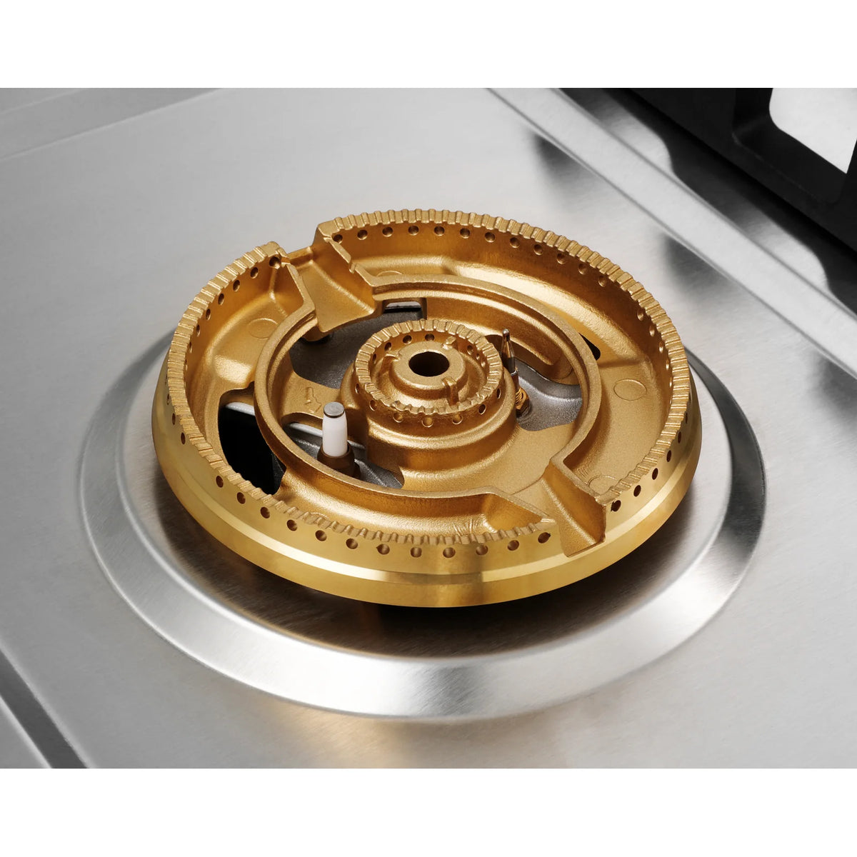 Close-up of the brass dual ring burner with ignition electrode on the ROBAM BrassPro ZG81H61 gas cooktop